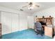 Bedroom with white walls, carpet flooring, and ceiling fan. A desk is located in the corner at 9661 Se 173Rd Pl, Summerfield, FL 34491