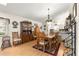 Dining room with hardwood floors and a view into the adjacent living areas and kitchen at 9661 Se 173Rd Pl, Summerfield, FL 34491