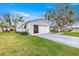 View of the home's exterior, featuring a well-maintained lawn, driveway, and attached garage at 9661 Se 173Rd Pl, Summerfield, FL 34491