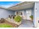 Inviting front porch featuring a seating area adorned with plants and decorative items at 9661 Se 173Rd Pl, Summerfield, FL 34491