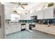 Kitchen features white cabinetry, black appliances, tile flooring, and granite countertops at 9661 Se 173Rd Pl, Summerfield, FL 34491