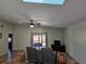 A light and airy living room featuring a ceiling fan, tiled floors, and sliding glass doors at 10831 Se 50Th Ter, Belleview, FL 34420