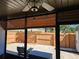 Screened patio offering a view of the fenced backyard with bench and table at 10831 Se 50Th Ter, Belleview, FL 34420