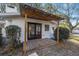 Covered deck with wood posts and tin roof, with double doors into home at 1126 Ne 34Th Ave, Ocala, FL 34470