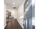 Hallway with dark wood floors, white walls, and a view into the living room and outdoor patio at 1126 Ne 34Th Ave, Ocala, FL 34470