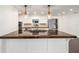 Close up of kitchen island featuring a stovetop, sink and stainless steel appliances at 1126 Ne 34Th Ave, Ocala, FL 34470