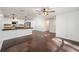 Bright open-concept living room featuring dark wood floors and a clear view of the modern kitchen at 1126 Ne 34Th Ave, Ocala, FL 34470