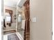 Bathroom featuring a glass shower, decorative curtain, and window at 11593 Sw 75Th Cir, Ocala, FL 34476