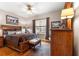 Beautiful bedroom featuring a wooden bed frame, side table, and natural light from the window at 11593 Sw 75Th Cir, Ocala, FL 34476