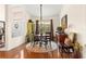 Cozy dining area with hardwood floors, round table, and natural light from the window at 11593 Sw 75Th Cir, Ocala, FL 34476