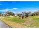 Inviting home exterior with green lawn, nice landscaping, gray paint, and a two-car garage at 11593 Sw 75Th Cir, Ocala, FL 34476