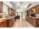 This kitchen features granite counters, wood cabinetry, stainless appliances, and tiled flooring at 11593 Sw 75Th Cir, Ocala, FL 34476