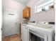 Bright laundry room with newer washer and dryer, sink, cabinet, and window at 11593 Sw 75Th Cir, Ocala, FL 34476