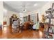 Bright living room with hardwood floors, multiple seating areas, and natural light at 11593 Sw 75Th Cir, Ocala, FL 34476