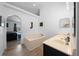 Bright bathroom featuring a soaking tub and a dual sink vanity at 11684 Sw 56Th Ter, Ocala, FL 34476