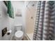 Neat bathroom featuring a toilet, a shower with a curtain, and a wall decor at 11684 Sw 56Th Ter, Ocala, FL 34476