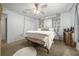 Well-lit bedroom featuring a plush bed, carpet flooring, a ceiling fan and a closet at 11684 Sw 56Th Ter, Ocala, FL 34476