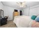 Bedroom featuring carpet, a ceiling fan, a closet, a comfortable bed and a black door at 11684 Sw 56Th Ter, Ocala, FL 34476