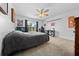 Bedroom with gray comforter, ceiling fan and a window providing natural light at 11684 Sw 56Th Ter, Ocala, FL 34476