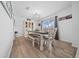 Bright dining area featuring wood-look floors and stylish light fixture at 11684 Sw 56Th Ter, Ocala, FL 34476