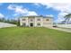 Attractive two-story home with a well-maintained lawn, long driveway, and classic architectural details at 11684 Sw 56Th Ter, Ocala, FL 34476