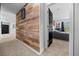 Hallway with wood-look accent wall leads to carpeted bedroom at 11684 Sw 56Th Ter, Ocala, FL 34476