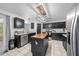 Beautiful kitchen with a center island, black cabinets, and modern lighting fixtures at 11684 Sw 56Th Ter, Ocala, FL 34476