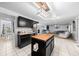 Open concept kitchen featuring a butcher block island, stainless fridge, and view to the living area at 11684 Sw 56Th Ter, Ocala, FL 34476