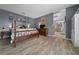 Cozy main bedroom with wood-look floors and vintage-inspired decor at 11684 Sw 56Th Ter, Ocala, FL 34476