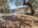 Exterior back of home showing door and small patio area at 12461 Se 126Th Ct, Ocklawaha, FL 32179