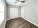 Bedroom featuring wood floors, a ceiling fan, and a closet, exuding comfort and practicality at 12461 Se 126Th Ct, Ocklawaha, FL 32179