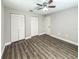 Bedroom featuring wood floors, a ceiling fan, and two closets, exuding comfort and practicality at 12461 Se 126Th Ct, Ocklawaha, FL 32179