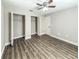 Bedroom featuring wood floors, ceiling fan and double closets at 12461 Se 126Th Ct, Ocklawaha, FL 32179