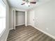 Bedroom featuring wood floors, a ceiling fan, and a closet, offering comfort and practicality at 12461 Se 126Th Ct, Ocklawaha, FL 32179