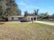 Exterior view of home featuring covered carport and long driveway at 12461 Se 126Th Ct, Ocklawaha, FL 32179