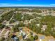 Aerial view of house in a neighborhood of many homes surrounded by many trees at 13 Pine Course Radl, Ocala, FL 34472