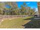 Large backyard with green grass and tall, wooden fence at 13 Pine Course Radl, Ocala, FL 34472