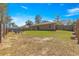 View of back of the house and patio furniture in a fenced backyard at 13 Pine Course Radl, Ocala, FL 34472