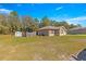 Exterior view of the home with a large lawn and storage shed at 13 Pine Course Radl, Ocala, FL 34472