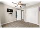 Bedroom with ceiling fan, carpet, double closets and TV on the wall at 13 Pine Course Radl, Ocala, FL 34472