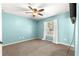 A simple bedroom with carpet, fan and window with white curtains at 13 Pine Course Radl, Ocala, FL 34472