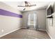 Carpeted bedroom with ceiling fan and accent stripe on the wall at 13 Pine Course Radl, Ocala, FL 34472