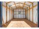 Interior of shed with wooden frame, white siding and wood flooring at 13 Pine Course Radl, Ocala, FL 34472