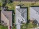 Aerial view of a well-maintained property featuring manicured lawns and a gray roof at 13340 Se 86Th Cir, Summerfield, FL 34491