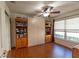 Bedroom featuring a ceiling fan, built-in shelving, a closet, and large windows at 13340 Se 86Th Cir, Summerfield, FL 34491