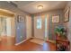 Bright and airy foyer with hardwood floors, a decorative front door and a nearby bathroom at 13340 Se 86Th Cir, Summerfield, FL 34491