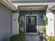 Cozy front porch with decorative plants and seating, perfect for relaxing outdoors at 13340 Se 86Th Cir, Summerfield, FL 34491