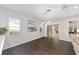 Well-lit dining area featuring dark wood floors and a modern chandelier at 13625 Se 93Rd Court Rd, Summerfield, FL 34491