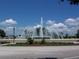 Decorative fountain with benches, landscaping, and palm trees at 13625 Se 93Rd Court Rd, Summerfield, FL 34491