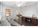 Bright office with desk, dark hardwood floors, and a view into the living room at 13625 Se 93Rd Court Rd, Summerfield, FL 34491